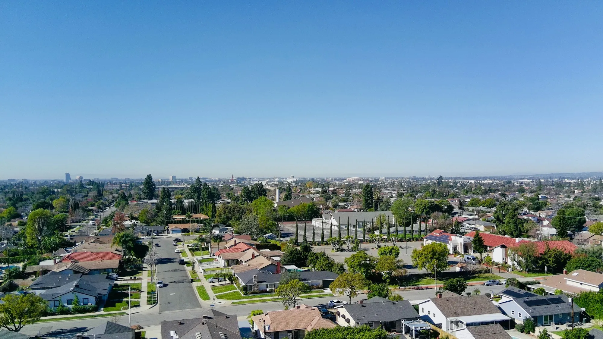 Aerial view of a suburban neighborhood with tree-lined streets
